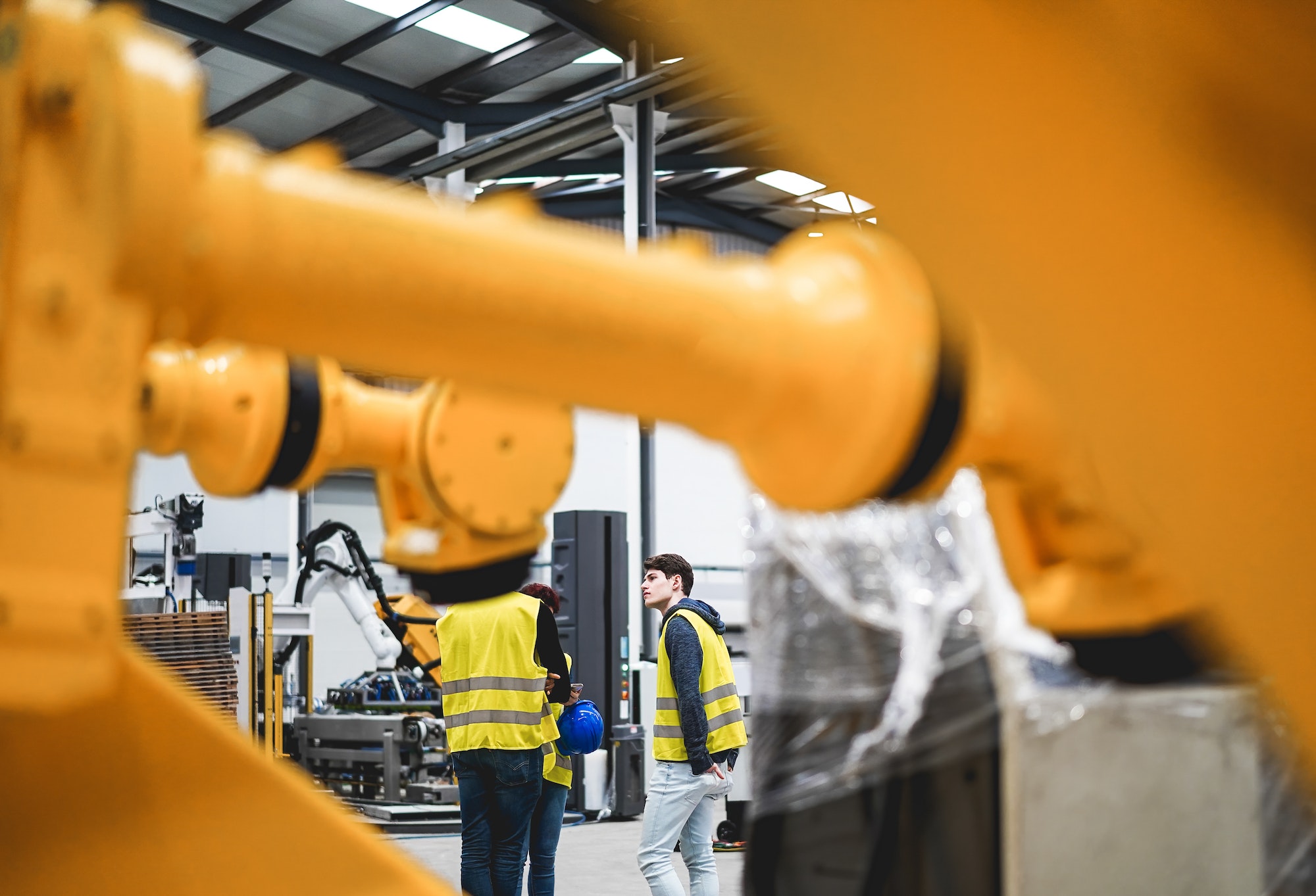 Engineers working inside robotic factory - Industrial and technology concept